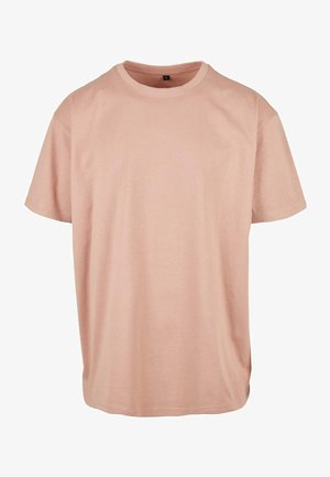 Lyserød bomulds T-shirt med korte ærmer, rund halsudskæring og løs pasform. Glat tekstur uden synlige mønstre eller pynt.