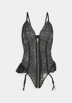 Body in pizzo nero con motivo floreale, chiusura frontale con zip, spalline regolabili e bordi arricciati. Presenta bretelle a reggicalze con dettagli in hardware dorato.