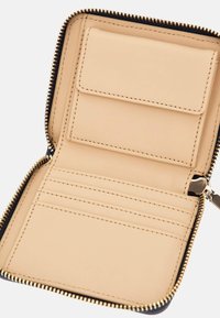 Zippered wallet, black exterior, tan leather interior, featuring one card slot and multiple card slots separated by stitching.