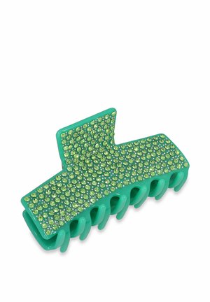 Grüner Acryllackenclip mit strukturierten Oberflächen, verziert mit hellgrünen Strasssteinen, mit geschwungenem Design und mehreren Haltezähnen.