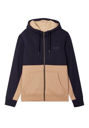 Felpa con zip e cappuccio, con parte superiore blu navy e parte inferiore beige, dotata di un rivestimento interno in pile e tasche frontali.