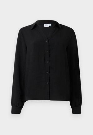 Chemise noire à manches longues avec col, en tissu texturé, comportant huit boutons à l'avant et des poignets élastiqués.