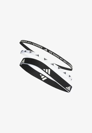 Set of three elastic hairbands: one black with white pattern, one white with black pattern, and one black with logo text in white.