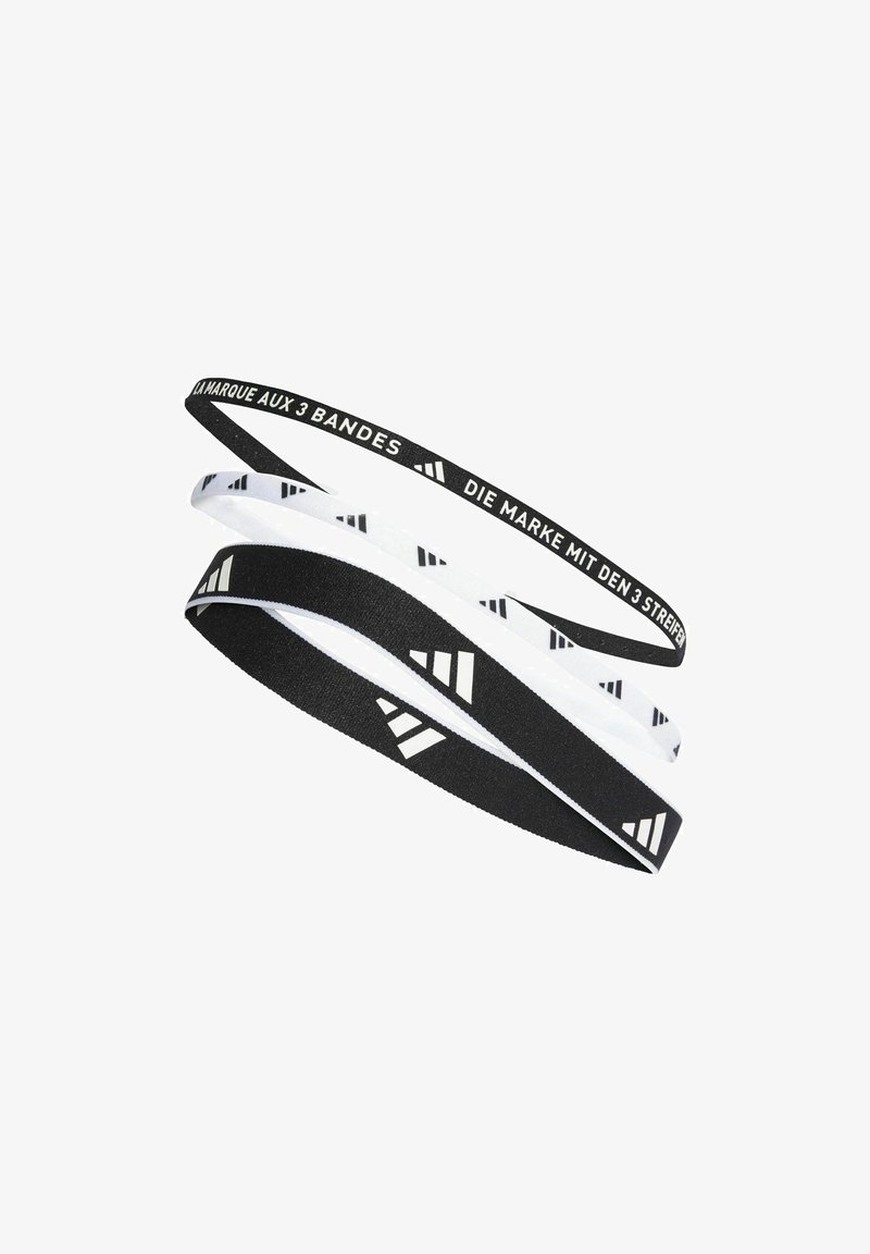 Set of three elastic hairbands: one black with white pattern, one white with black pattern, and one black with logo text in white.