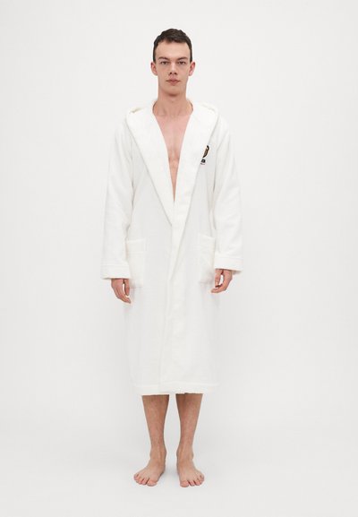 White terry cloth bathrobe with a hood, long sleeves, front pockets, and a relaxed fit. Features a logo on the chest.