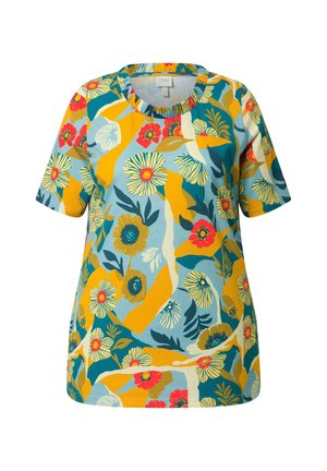 Camisa de manga corta con un patrón floral abstracto en colores amarillo, verde azulado, azul, rojo y crema sobre un fondo azul claro.