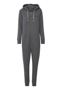 Tuta in pile grigio con zip frontale, cappuccio e coulisse. Presenta maniche lunghe e caviglie con polsini. Dettaglio del logo marrone sul petto.
