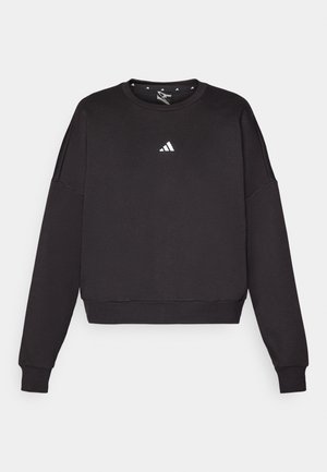 Black sweatshirt with long sleeves, round neckline, and cropped hem. Features a small white Adidas logo on the chest. Soft material.