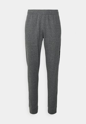 Pantalon de survêtement fuselé gris foncé avec taille et poignets élastiques, en tissu doux, présenté sur un fond blanc.