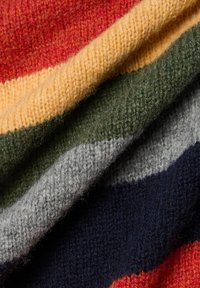 Woolen textile featuring horizontal stripes in red, yellow, green, gray, and navy. Soft texture with a warm, layered appearance.