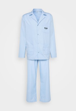 Light blue two-piece pajama set featuring a button-up jacket with a chest pocket and loose-fitting pants. Made from soft fabric.