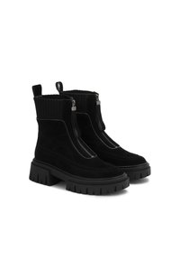 Botas negras hasta el tobillo con acabado de ante, parte superior tipo calcetín con relieve, doble cremallera y suelas de goma gruesa para una mejor tracción.