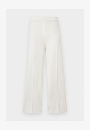 Pantalon blanc taille haute à jambes larges avec fermeture éclair dissimulée à l'avant et design minimaliste sur fond uni.