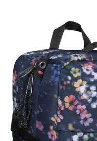 Navy blue backpack with multicolored floral pattern, black zippers with pull cords, and a black fabric handle on top.