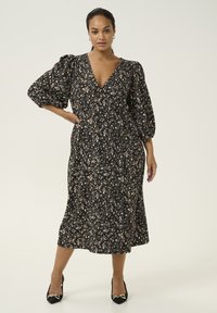 Black floral dress with a deep V-neckline and puffed sleeves, featuring a flowy mid-length skirt and a small, colorful floral pattern.