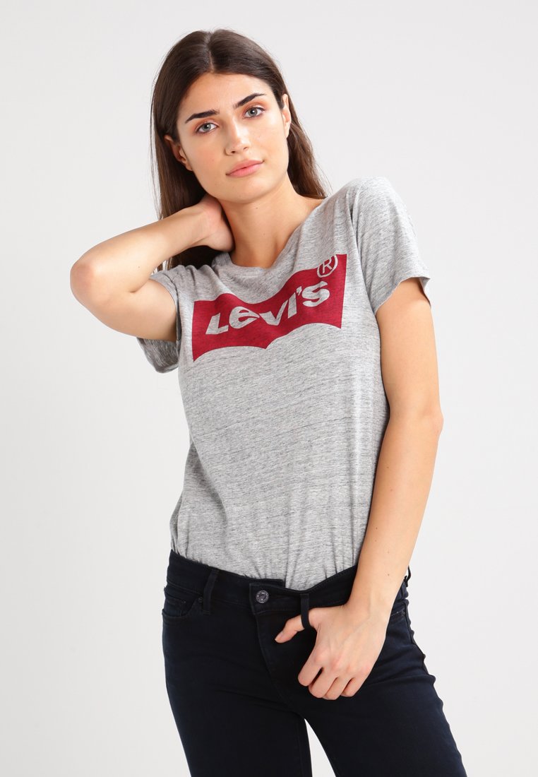 Grå T-shirt med korte ærmer, der har et fremtrædende rødt Levi's-logo på fronten. Stoffet ser blødt ud med en let meleret tekstur.