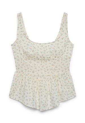 Blouse sans manches de couleur crème avec un petit motif floral rose et vert, et un ourlet à volant.