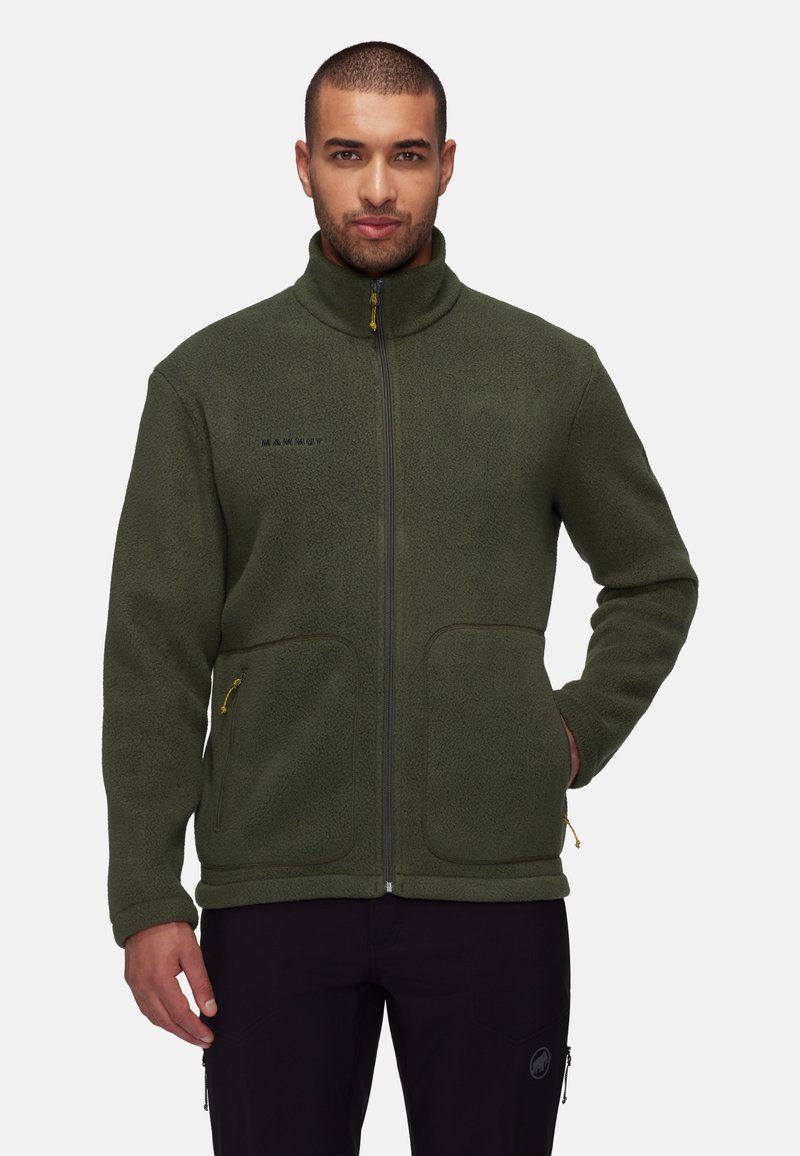 Fleece jacket in dark green with a high collar, full zipper, two front pockets, and yellow zipper details. Features a soft texture.