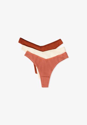 Set di tre perizomi a costine in terracotta, beige chiaro e marrone scuro. Presentano un design a forma di V con tessuto morbido e elasticizzato.