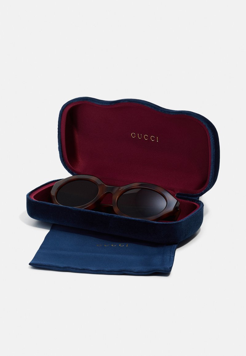 Gucci-Sonnenbrille in einem dunklen Schildpatt-Rahmen, geliefert in einem navyblauen Samt-etui mit maroonem Innenfutter; inklusive einem blauen Reinigungstuch.