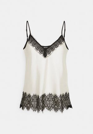 Camisole en satin blanc avec bordure en dentelle noire sur l'encolure en V et l'ourlet, avec bretelles fines noires réglables.