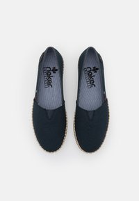 Navy canvas slip-on shoes with a textured surface, striped insole, and a natural woven sole detail. Features logo on insole and side accent.