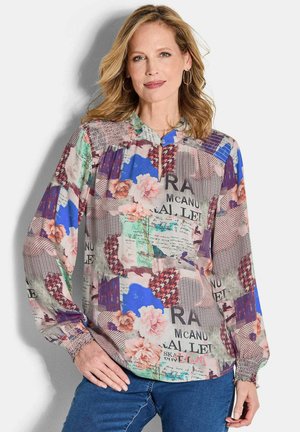 Morekleurige blouse met bloemen- en geometrische ontwerpen in tinten blauw, groen en roze. Lange mouwen met gathers aan de manchetten en een staande kraag.