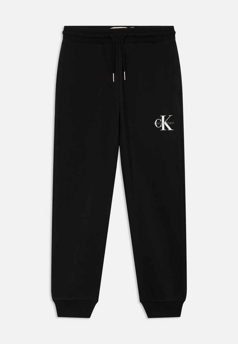 Melnas sporta bikses ar elastīgu jostu, auklu un ribotām aprocēm. Malā ir balts Calvin Klein logo. Gluda tekstūra.