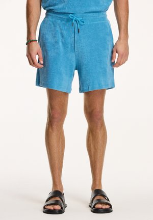 Pantaloni corti in spugna turchese con vita elastica e coulisse, caratterizzati da una vestibilità comoda e lunghezza sopra il ginocchio.