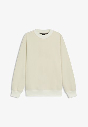 Cream-colored sweatshirt in soft fabric, with ribbed collar and cuffs, drop shoulders, and a relaxed fit. No visible patterns or accents.