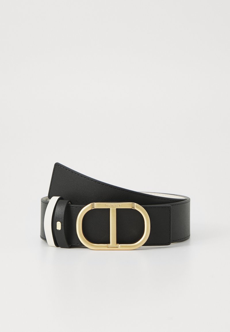 Svart lærbelte med en gull oval spenne med et "T" design. Inkluderer en kontrasterende hvit stripe på den ene siden.