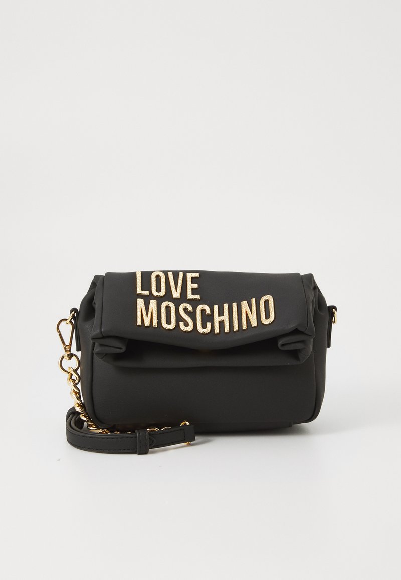 Black fold-over shoulder bag with gold chain strap and large gold "LOVE MOSCHINO" letters on the front flap.