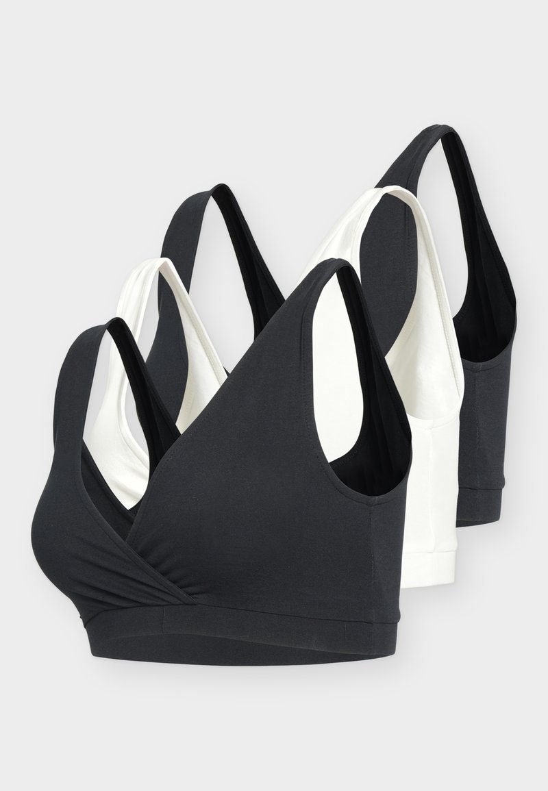 Négy fekete-fehér, vezeték nélküli, ujjatlan sportmelltartó szett, széles vállpántokkal és mély V-nyakkivágással.