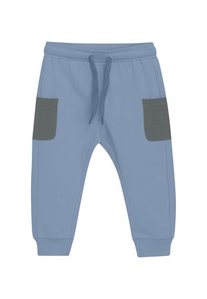 Ljusblå joggingbyxor med dragsko i midjan, med två gråa fickor i fram och ribbade muddar vid anklarna.