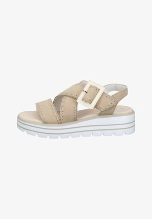 Beige platform sandal with thick white sole, two wide straps crossing over front, adjustable large square buckle, and back strap.