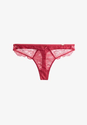 Spitzen-Tanga in tiefrot mit floralem Muster, ausgestattet mit einem zarten gewellten Rand und einem V-förmigen Frontschnitt. Leichtes und durchsichtiges Material.
