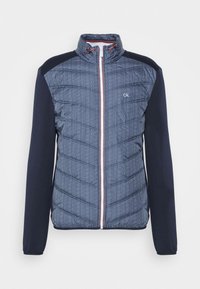 Quilted navy blue jacket with a herringbone pattern on the front, contrasting dark blue sleeves, and a white zipper with red accents.