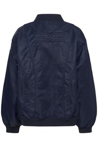 Navy blue bomber jacket with a smooth, shiny texture, ribbed cuffs, and collar, featuring a unique stitched logo on the back.