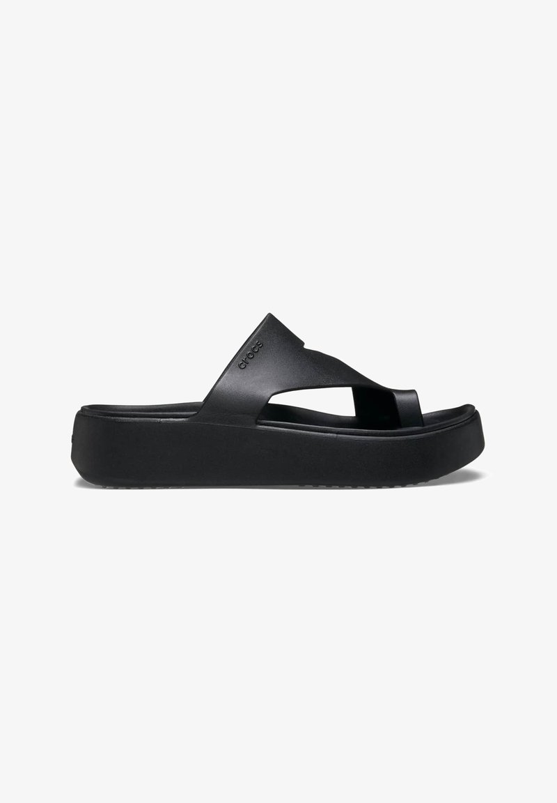 Black platform flip-flop with a textured rubber sole, featuring cross-strap design and a matte finish. Brand logo understated on the side.