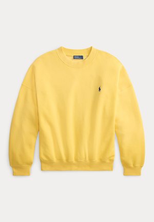 Sweat-shirt jaune à col rond en coton doux. Il présente des poignets et un ourlet côtelés, avec un petit logo marine sur le côté gauche de la poitrine.