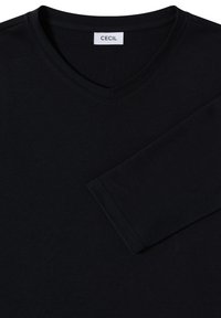 T-shirt noir à col en V avec manches longues. Confectionné dans un tissu lisse. Présente une étiquette "CECIL" au niveau du col. Design simple, sans motifs.