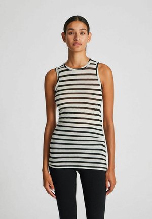 Striped sleeveless top in light gray and dark gray, slightly sheer fabric, round neckline, fitted design, paired with black fitted pants.