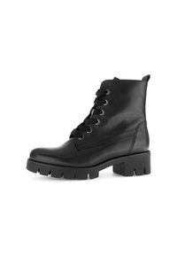 Bottines en cuir noir avec un laçage à l'avant, bout rond, semelle texturée et talon épais. Présente des œillets en argent et des détails de couture sur le côté.