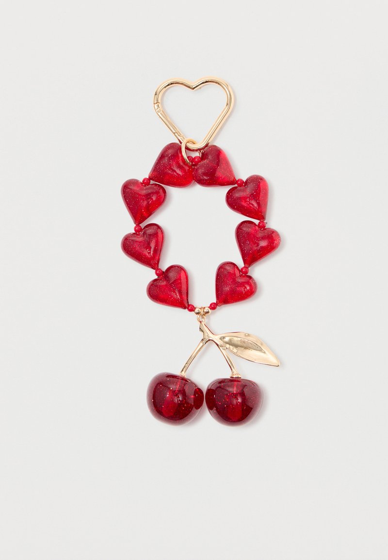 Red heart and cherry keychain made of glossy plastic with gold-tone metal accents, featuring a heart-shaped clasp and glitter details.