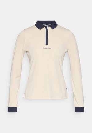 Langärmliges Poloshirt aus cremefarbenem Stoff mit navyfarbener Kragen und Bündchen. Verfügt über eine zentrale Knopfleiste und ein gesticktes "Calvin Klein"-Logo.