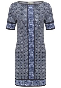 Marindress med korta ärmar, prydd med ett blommönster, kontrasterande kanter och ett centralt band med cirkulära mönster. Mjuk tygtextur.