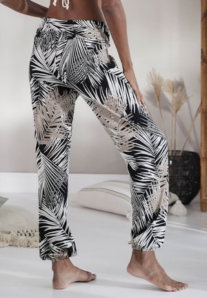 Black and white palm leaf patterned lightweight pants with a gathered ankle design, featuring an elastic waistband and casual fit.