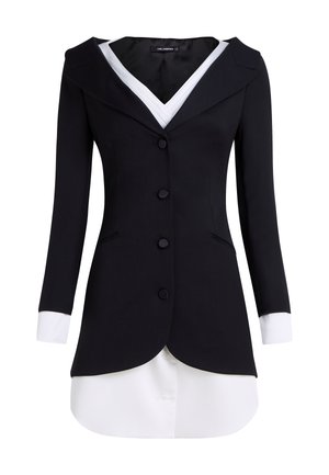 Tailored black blazer with a white collar and cuffs, structured design, six front buttons, and a curved hemline for added visual interest.