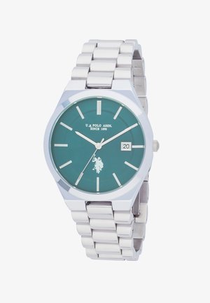 Silver metal bracelet watch with green dial, white hour markers, date display at 3 o'clock, and U.S. Polo Assn. logo and text on face.