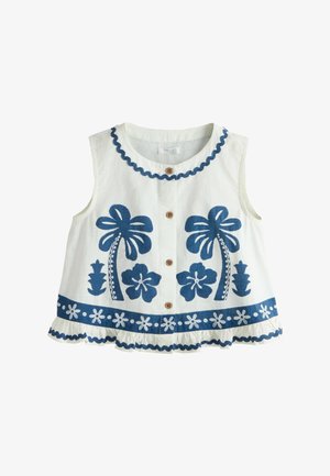 Ärmellose weiße Bluse mit blau bestickten Palmen, Blumen und gerafftem Saum, vorne mit braunen Knöpfen.